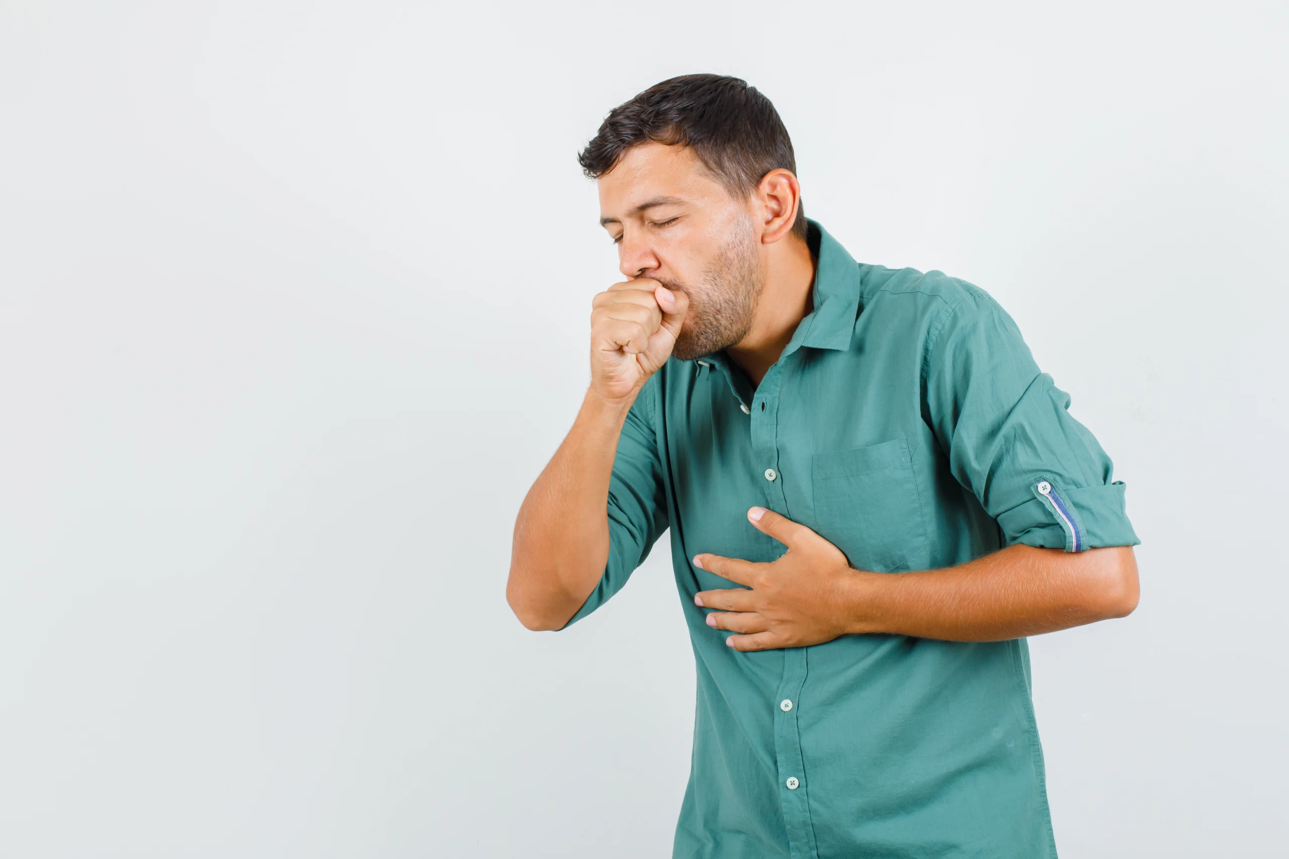 Man experiencing persistent cough and breathing discomfort related to lung health issues